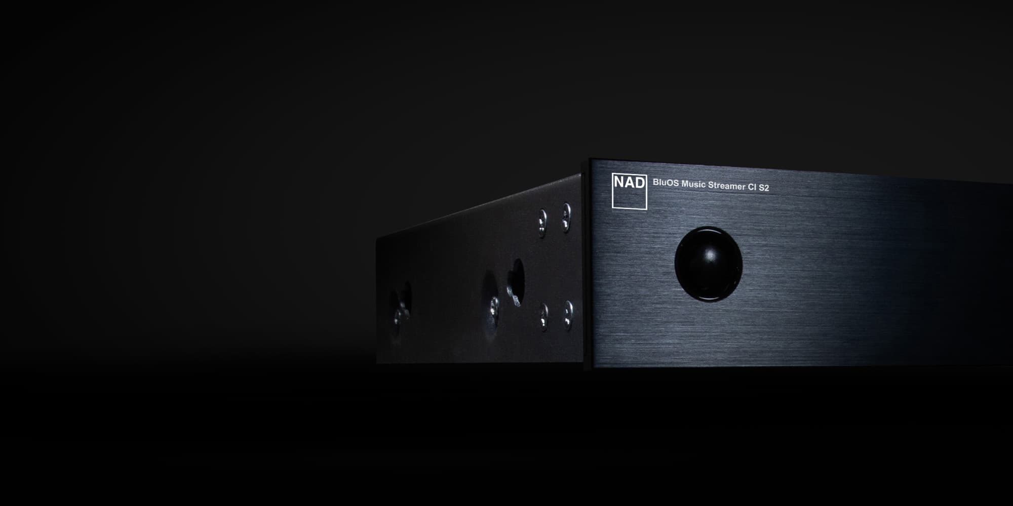 NAD CI S2 BluOS Music Streamer in a dark studio setting